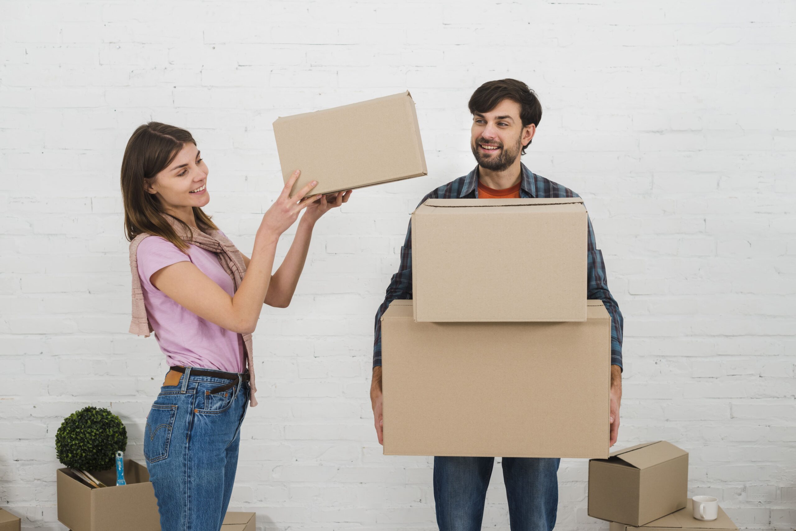 smiling-woman-placing-stack-cardboard-boxes-his-husband-s-hand-1